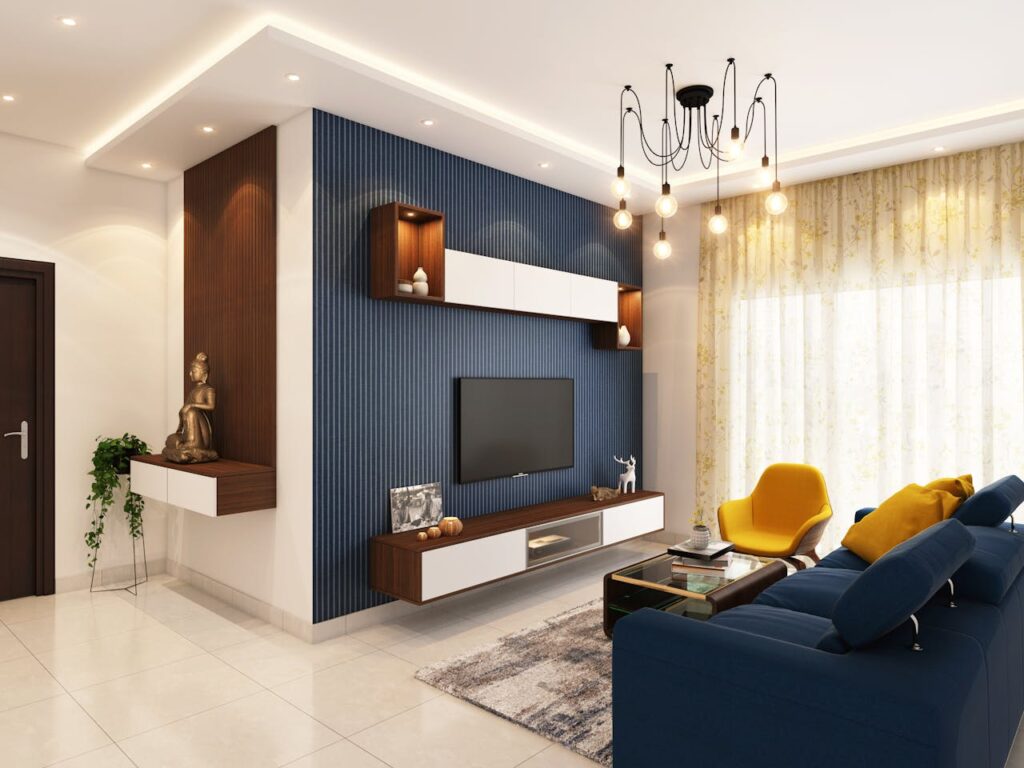 living room with blue feature wall, blue couch, and light floor